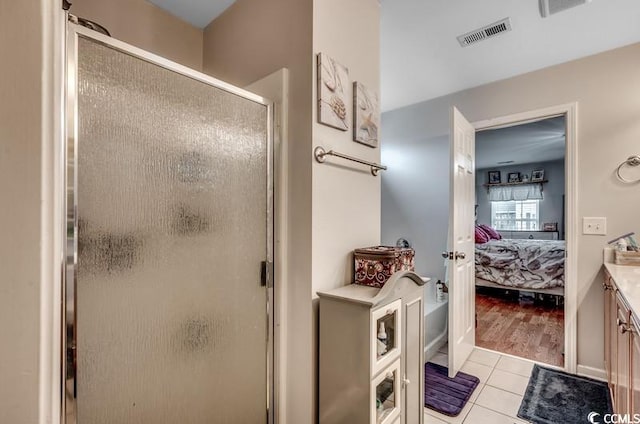 ensuite bathroom with vanity, visible vents, a shower stall, tile patterned floors, and connected bathroom