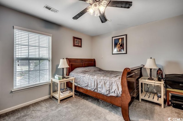 bedroom featuring visible vents, baseboards, carpet, and a ceiling fan