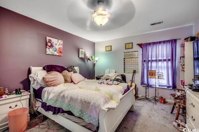 carpeted bedroom with visible vents and ceiling fan