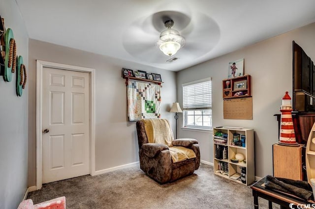 sitting room with baseboards, carpet floors, visible vents, and ceiling fan