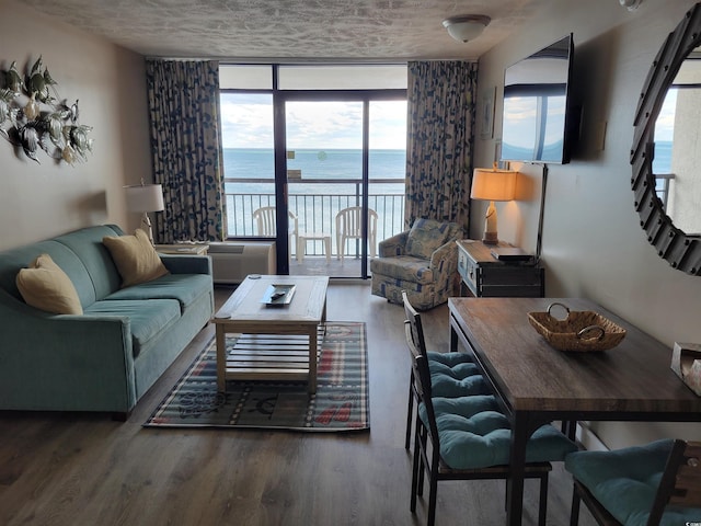 living room with wood finished floors and floor to ceiling windows