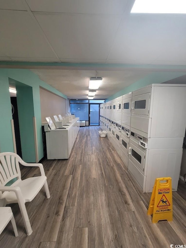 kitchen with wood finished floors and stacked washer and dryer