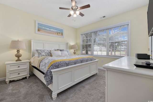 bedroom with visible vents, carpet floors, baseboards, and a ceiling fan