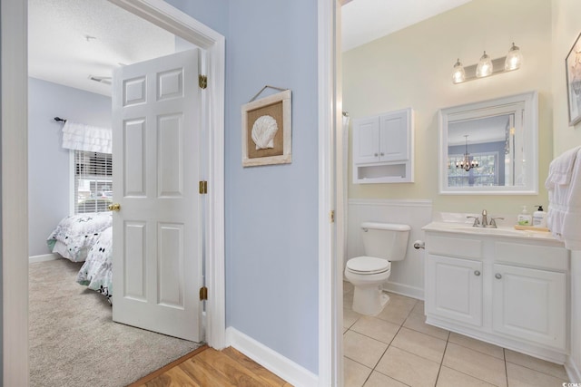 ensuite bathroom with plenty of natural light, toilet, vanity, and ensuite bathroom