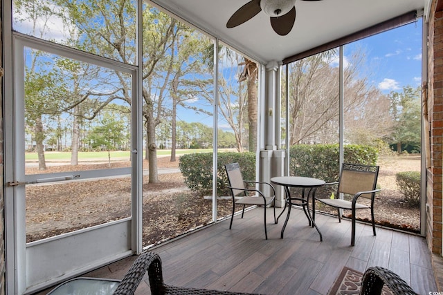 unfurnished sunroom with a ceiling fan and a wealth of natural light