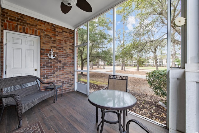 sunroom featuring a ceiling fan