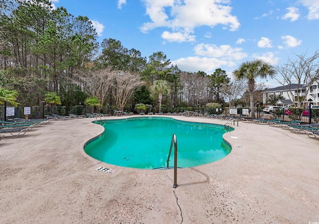 pool featuring a patio and fence