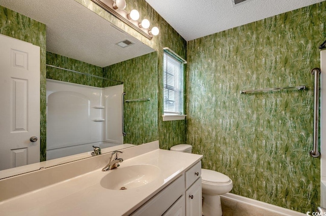 bathroom featuring vanity, a textured ceiling, visible vents, walk in shower, and toilet