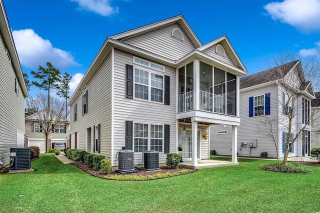 view of front of home with a front lawn, cooling unit, and a sunroom