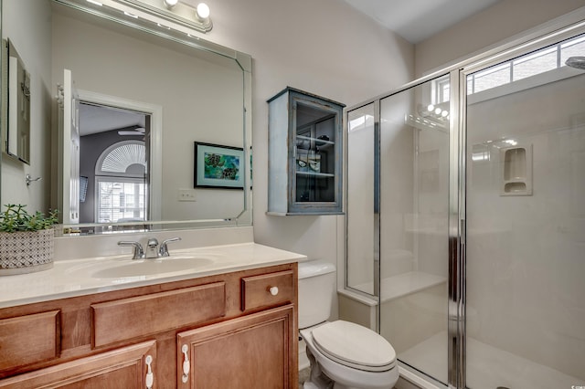 full bath with toilet, a stall shower, and vanity