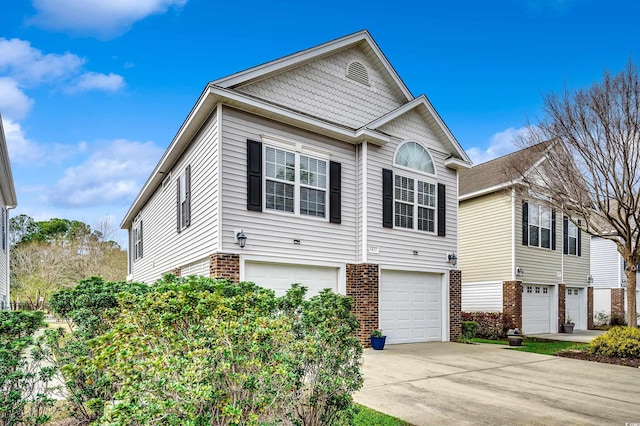 view of front of house with brick siding, concrete driveway, and a garage