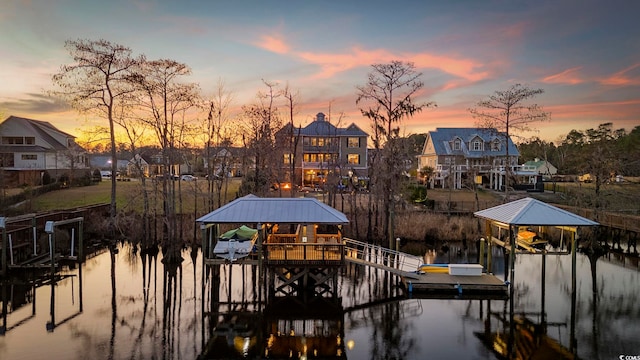 dock area with a water view and boat lift