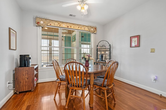 dining space featuring a healthy amount of sunlight, visible vents, wood-type flooring, and baseboards