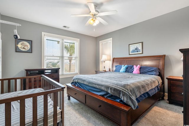 bedroom with visible vents, carpet floors, and ceiling fan