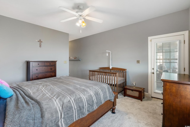 bedroom featuring light colored carpet and a ceiling fan