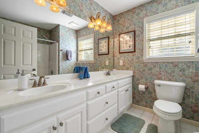 bathroom featuring visible vents, wallpapered walls, toilet, tile patterned floors, and a sink