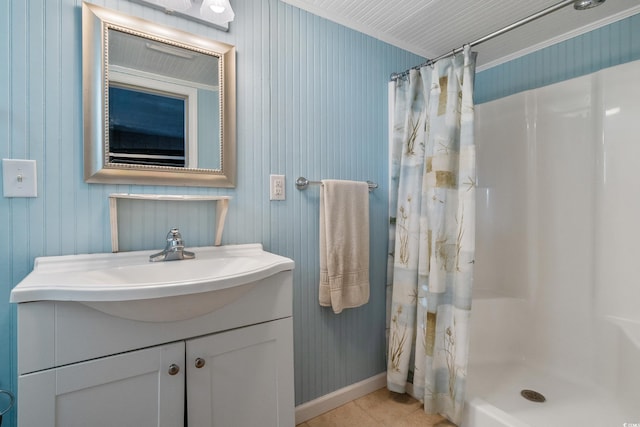 bathroom with tile patterned floors, baseboards, a shower with curtain, and vanity