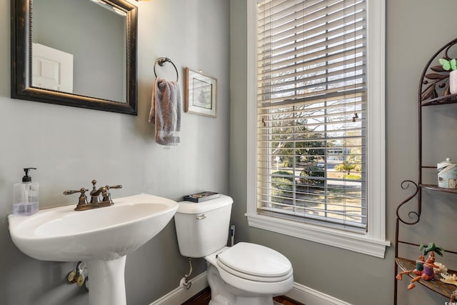 bathroom with toilet and baseboards