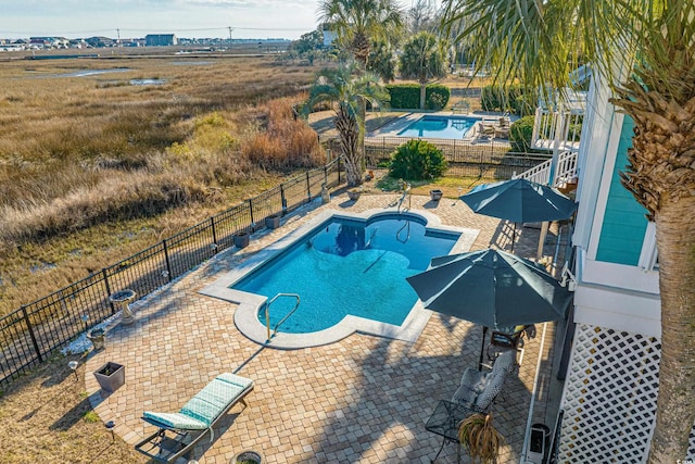 view of pool with a fenced in pool, a patio, and fence