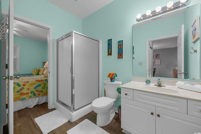 ensuite bathroom with a shower stall, ensuite bath, vanity, and wood finished floors