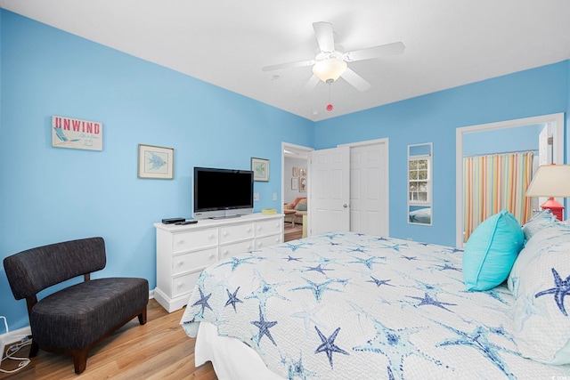 bedroom with baseboards, ceiling fan, and wood finished floors