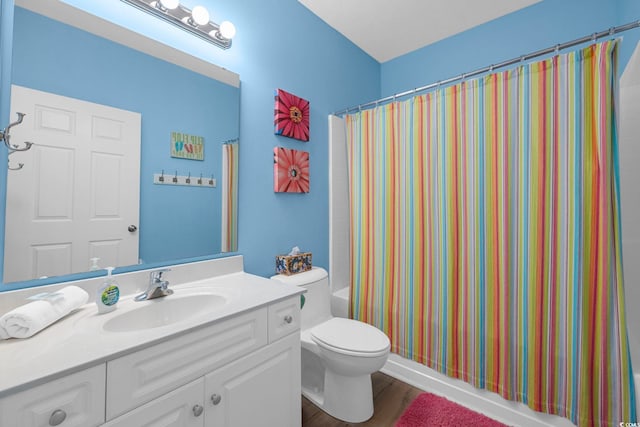 full bath with shower / bath combo, toilet, vanity, and wood finished floors