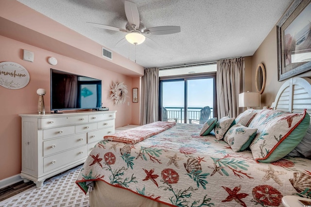 bedroom featuring visible vents, access to exterior, a textured ceiling, baseboards, and ceiling fan