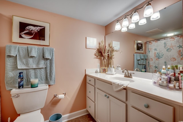 bathroom featuring visible vents, toilet, tile patterned flooring, baseboards, and vanity