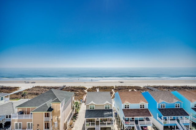 drone / aerial view featuring a residential view, a view of the beach, and a water view