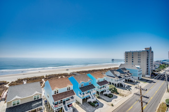 drone / aerial view featuring a beach view and a water view