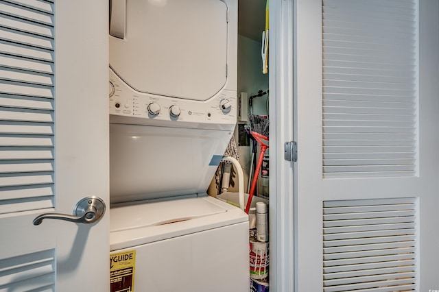 clothes washing area with laundry area and stacked washer and clothes dryer