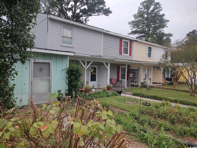 view of front of home with a porch and a front yard