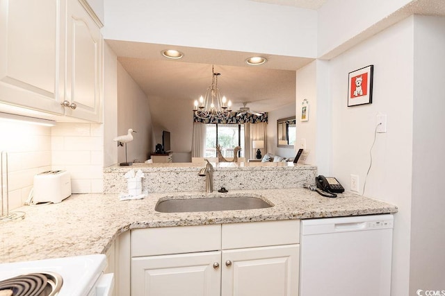 kitchen with white dishwasher, a sink, a chandelier, tasteful backsplash, and recessed lighting