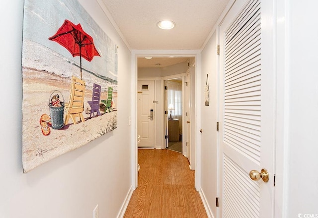 corridor featuring light wood-style floors, recessed lighting, and baseboards