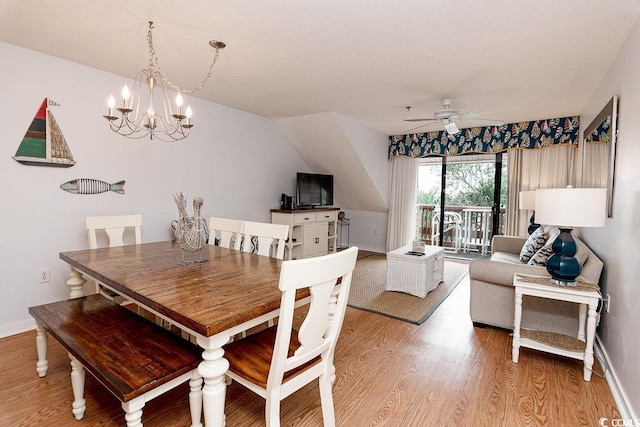 dining space with light wood-type flooring, a chandelier, ceiling fan, and baseboards