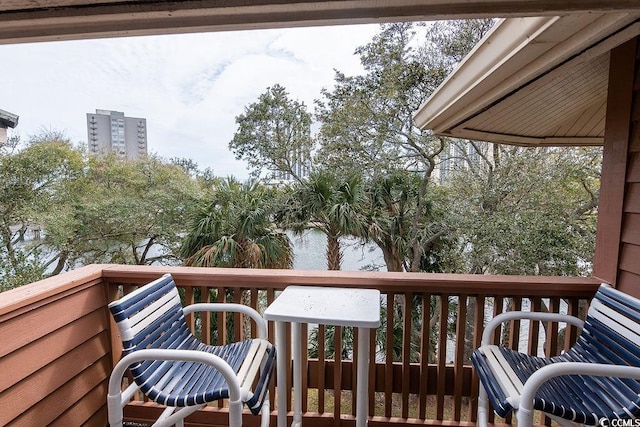wooden terrace featuring a water view