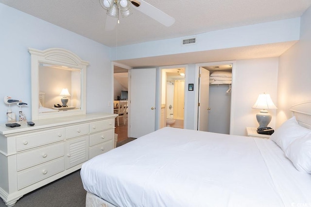 bedroom with ensuite bath and ceiling fan
