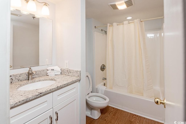 full bath featuring shower / tub combo with curtain, vanity, wood finished floors, and toilet