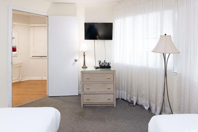 carpeted bedroom with connected bathroom