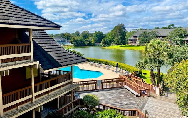 community pool with a deck with water view and a patio area