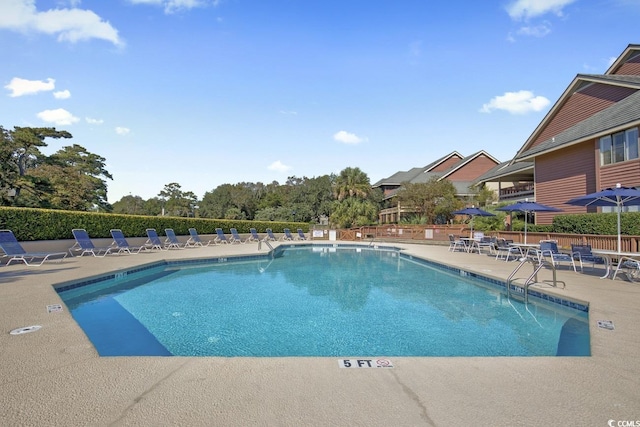 community pool with a patio area