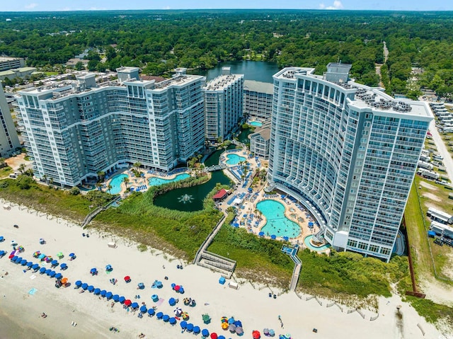 drone / aerial view with a water view and a view of trees