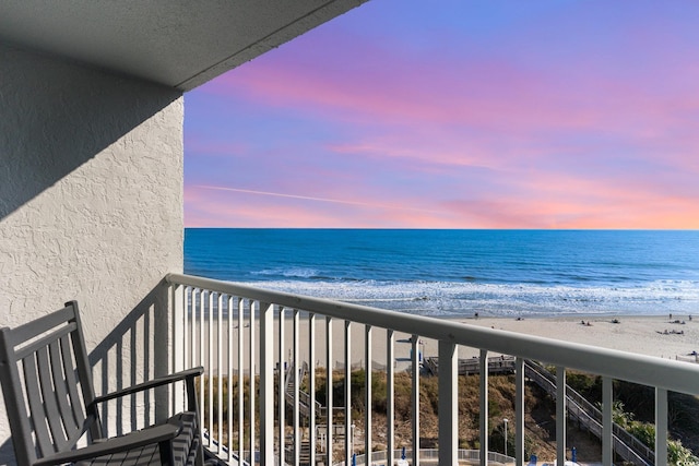 balcony with a beach view and a water view