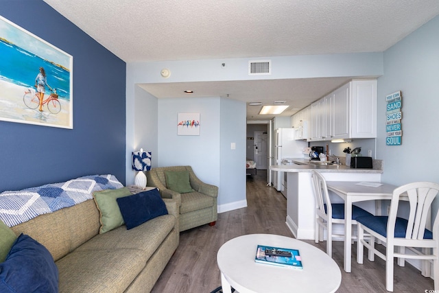 161 Seawatch Dr Unit 808, Myrtle Beach, SC 29572 - living room with visible vents, a textured ceiling, and dark wood-type flooring
