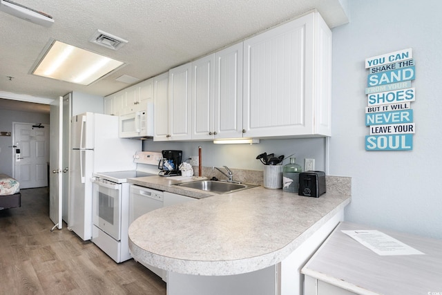161 Seawatch Dr Unit 808, Myrtle Beach, SC 29572 - kitchen with white appliances, visible vents, a sink, light wood-style floors, and white cabinetry