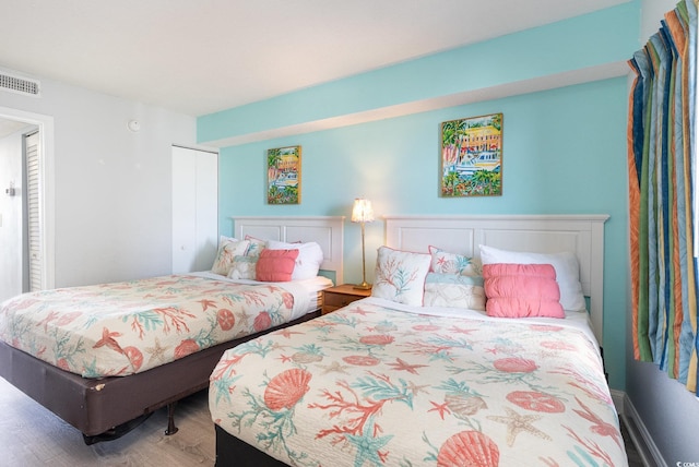 161 Seawatch Dr Unit 808, Myrtle Beach, SC 29572 - bedroom with visible vents, a closet, and wood finished floors