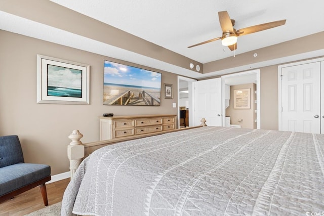 bedroom with ceiling fan, baseboards, and wood finished floors