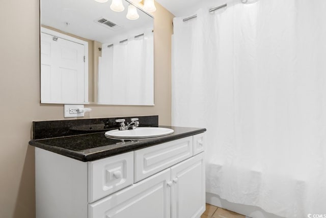 bathroom with tile patterned floors, visible vents, vanity, and shower / tub combo