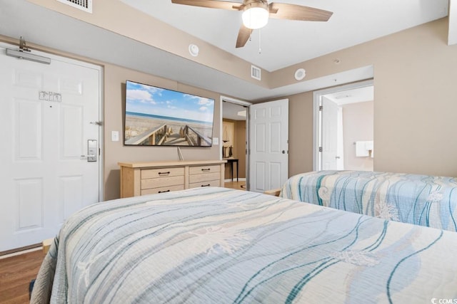 bedroom with visible vents, ceiling fan, and wood finished floors