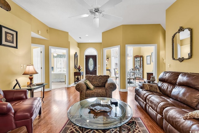 living area featuring ceiling fan, baseboards, and wood finished floors